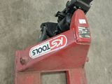 a close up of a red tool stand with a wren on it