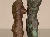 statue of a man and a woman standing next to each other on a table