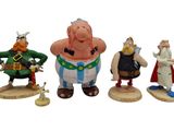 seven figurines of different characters on a white background