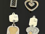 many different types of dog tags on a black surface