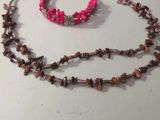 a necklace and bracelet that are on a table