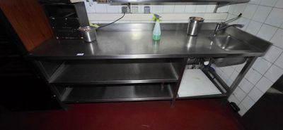 a kitchen with a sink, stove, and microwave in it