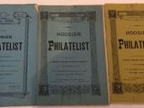 three books are lined up on a table with a white background
