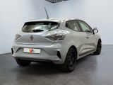 the rear end of a silver car in a white room