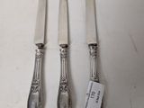 three silver plated knives and a knife on a white surface