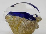 a glass fish that is sitting on top of a table