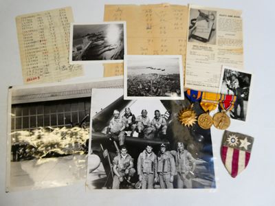 an old photo of a bunch of military memorabilia on top of a table