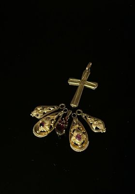 a close up of a cross on a black surface