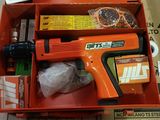 an orange box with a gun and other items in it