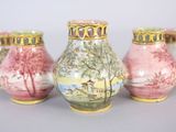 three vases with different designs on them sitting on a table