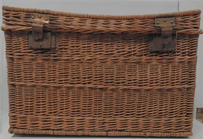 an old wicker trunk with two handles and a handle