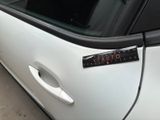 a sticker on the door of a white car