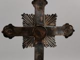 an old metal cross with a sunburst in the middle of it