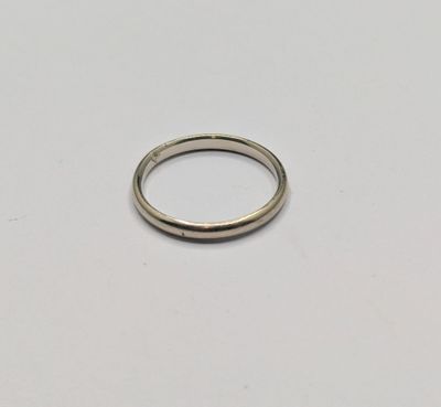 a close up of a silver ring on a white surface
