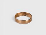 a close up of a gold ring on a white background