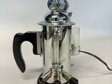 a close up of a coffee pot with a handle on a table