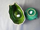 a green bowl and a green teapot sitting on a table