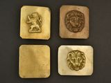 quatre têtes de lion plaquées or et une tête de lion sur fond noir