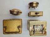 four different types of brass hardware on a white surface