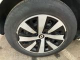the tire of a white car with a black rim is shown