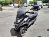 a scooter that is parked in a parking lot