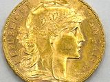 a close up of a gold coin on a white surface
