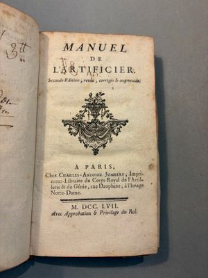 an old book with writing on it sitting on top of a table