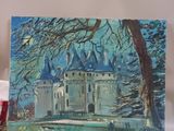 a painting of a castle on a table next to a candle