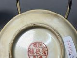 a white plate with a red design on it