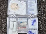a plastic case filled with medical supplies sitting on the ground
