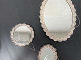 three mirrors that are on the table and one has a mirror