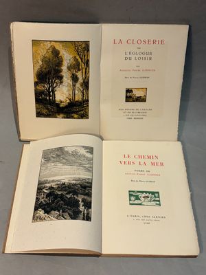two open books on a table with a picture of a landscape in the background