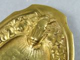 a close up of a gold plate with a horse on it