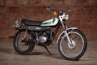 a motorcycle that is parked in front of a brick wall