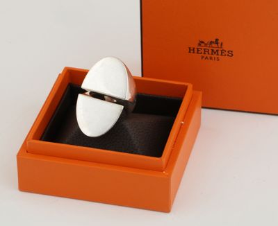 an orange box with a ring inside of it on a white surface