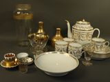 a table with a lot of gold and silver items on it