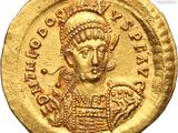 a close up of a gold coin with an image of a man