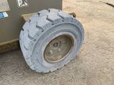 a tire that is sitting on the ground next to a machine