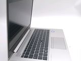 a silver laptop computer sitting on a white surface