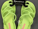 a pair of neon green sandals on a hanger