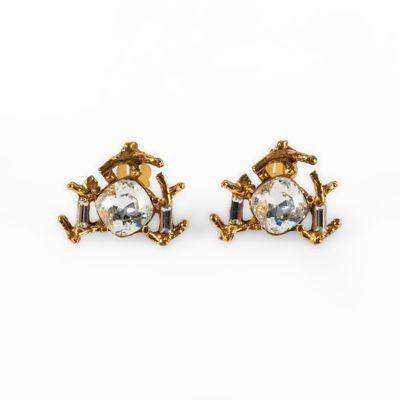 a pair of gold tone earrings with clear crystal stones