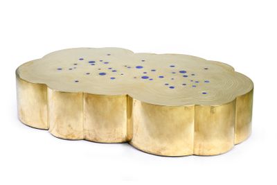 a close up of a gold coffee table with blue dots on it