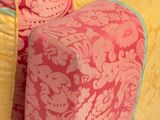 yellow, pink and blue patterned couch in a living room