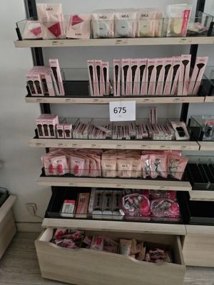 a lot of makeup products on the shelves in the store