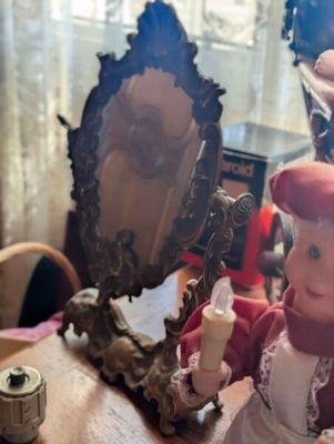 a doll that is sitting in front of a mirror