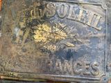 an old sign that is on the side of a brick wall