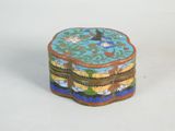 a small box with a bird on it sitting on a table