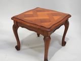 a small wooden table with a checkered top on a white background