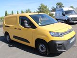 a yellow van that is parked in a parking lot