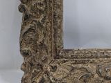 an old wooden frame with a carved design on it